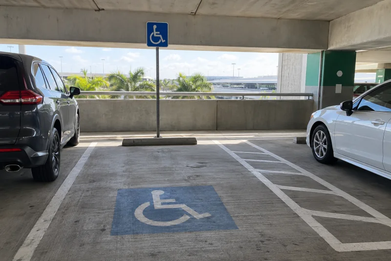 An accessible parking space with a blue wheelchair sign in an airport garage