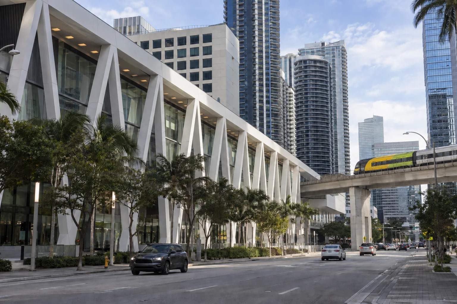 A modern train station with angled white roof trusses