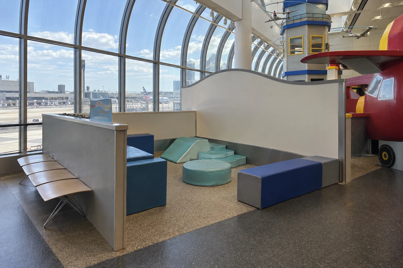 Soft play shapes by the windows in an airport play area