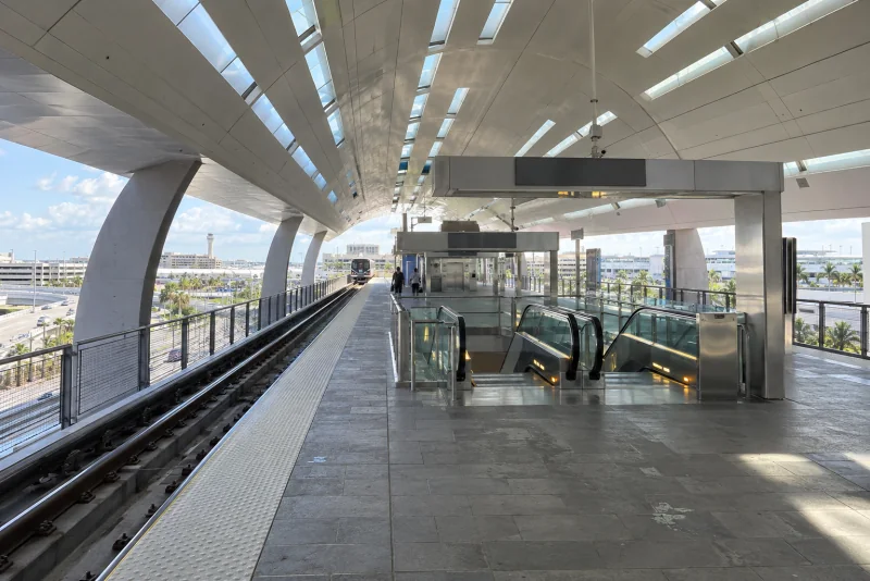 An elevated rail platform under a curved station roof