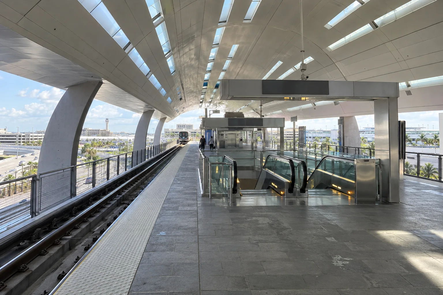 An elevated rail platform under a curved station roof