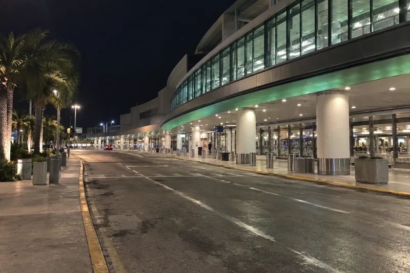 An empty airport arrivals curb at night