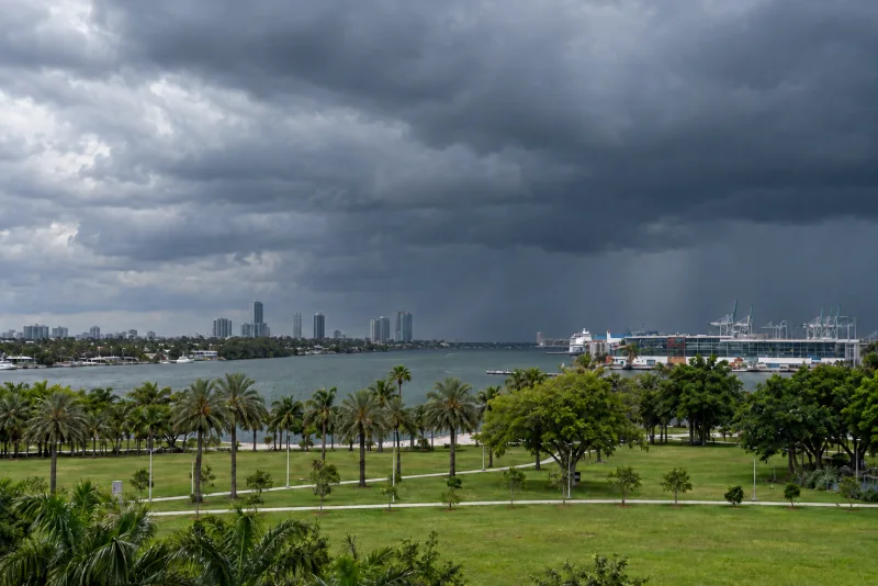 Dark rain clouds over the downtown Miami skyline across Biscayne Bay