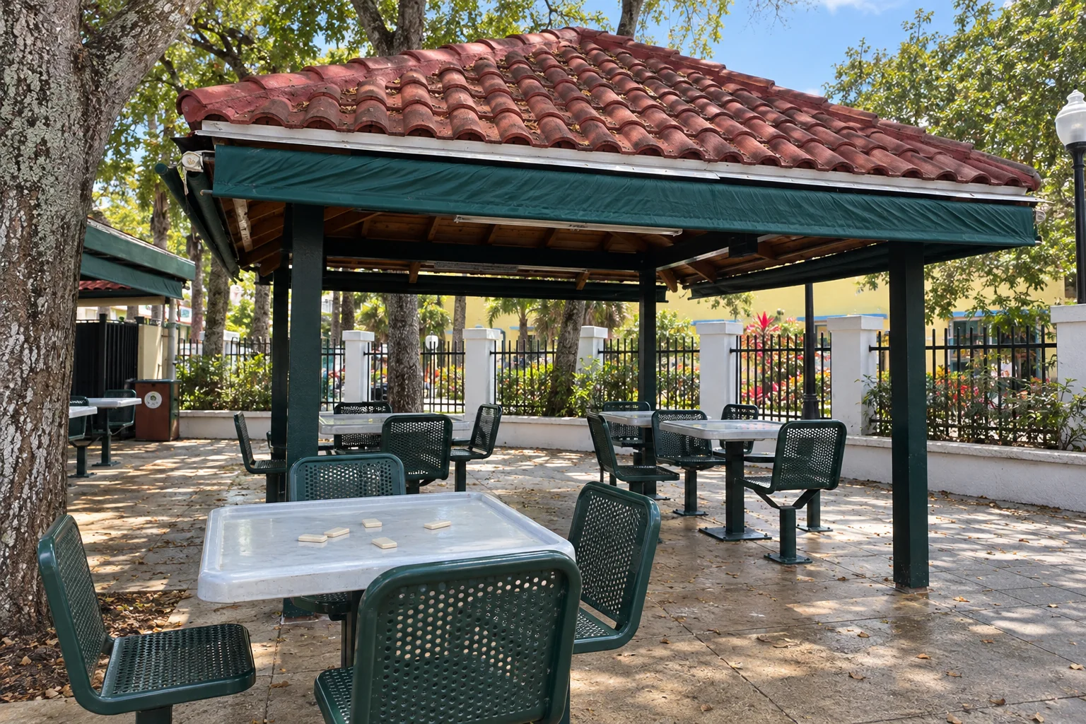 Empty domino tables under the pavilion in Domino Park, Little Havana