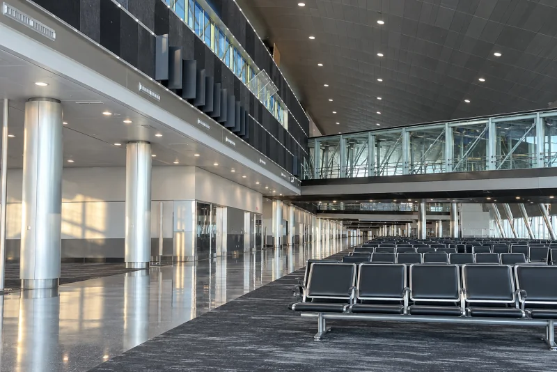 Rows of empty gate seats in a quiet concourse